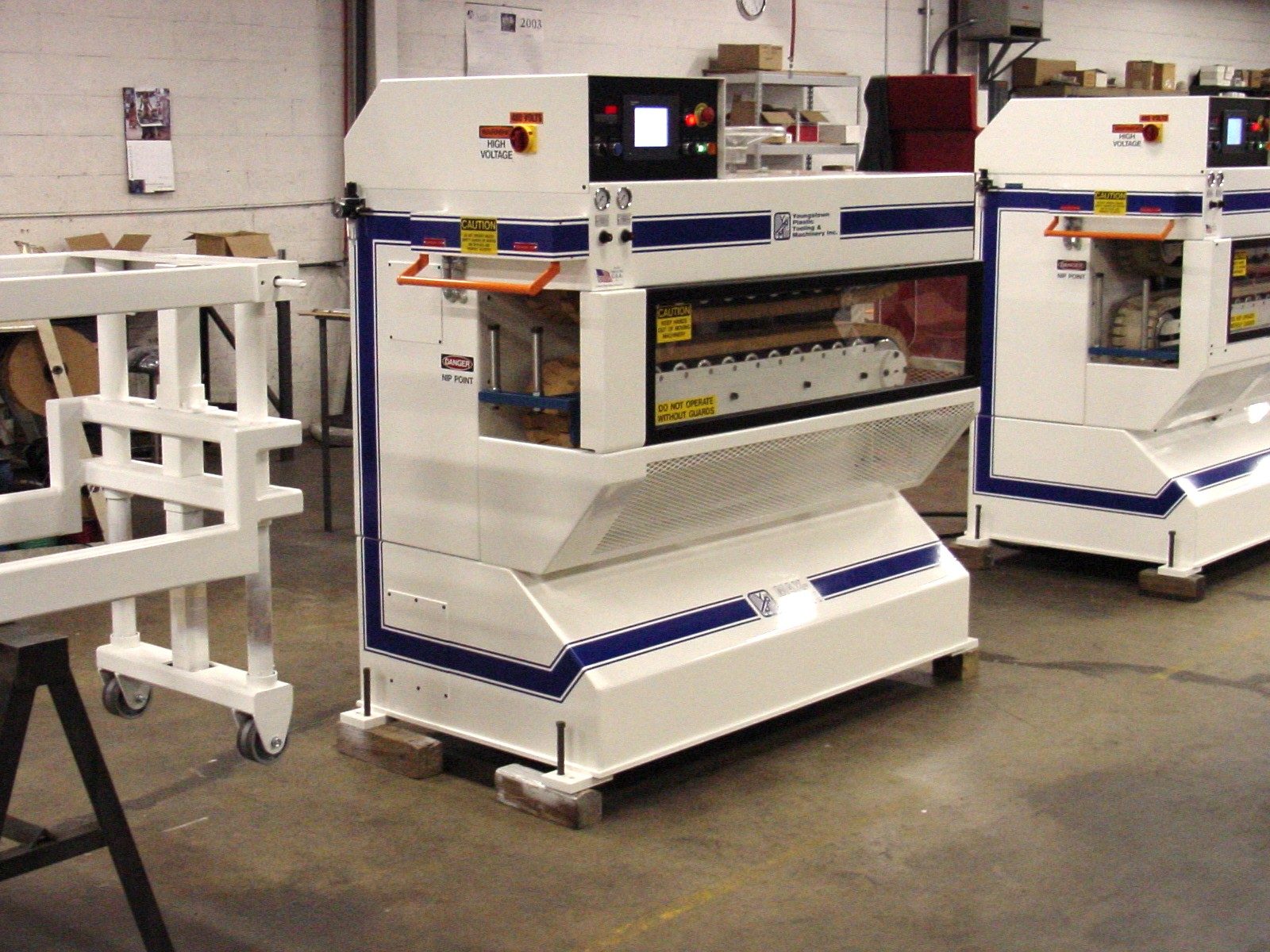 White YPTM machines with navy striping on the shop floor